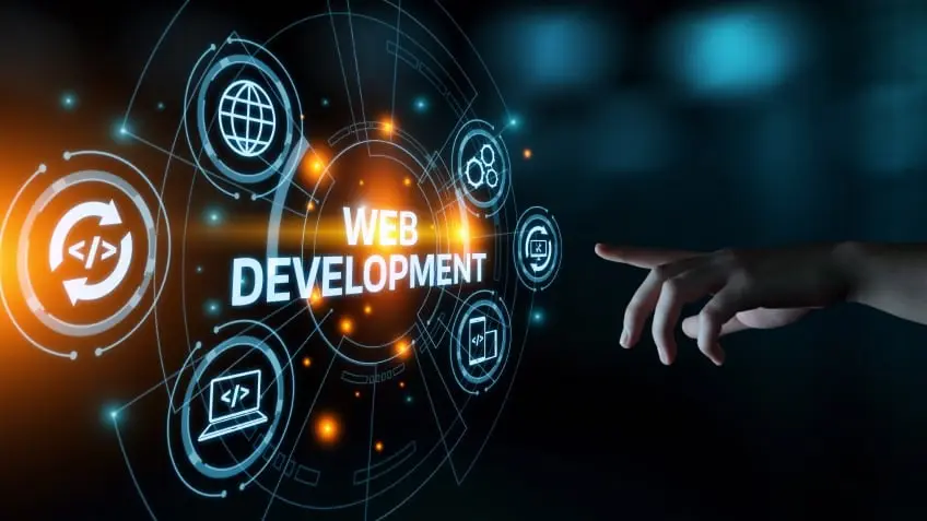 Futuristic digital graphic with bold WEB DEVELOPMENT typography surrounded by web coding icons and a hand interacting with the display.